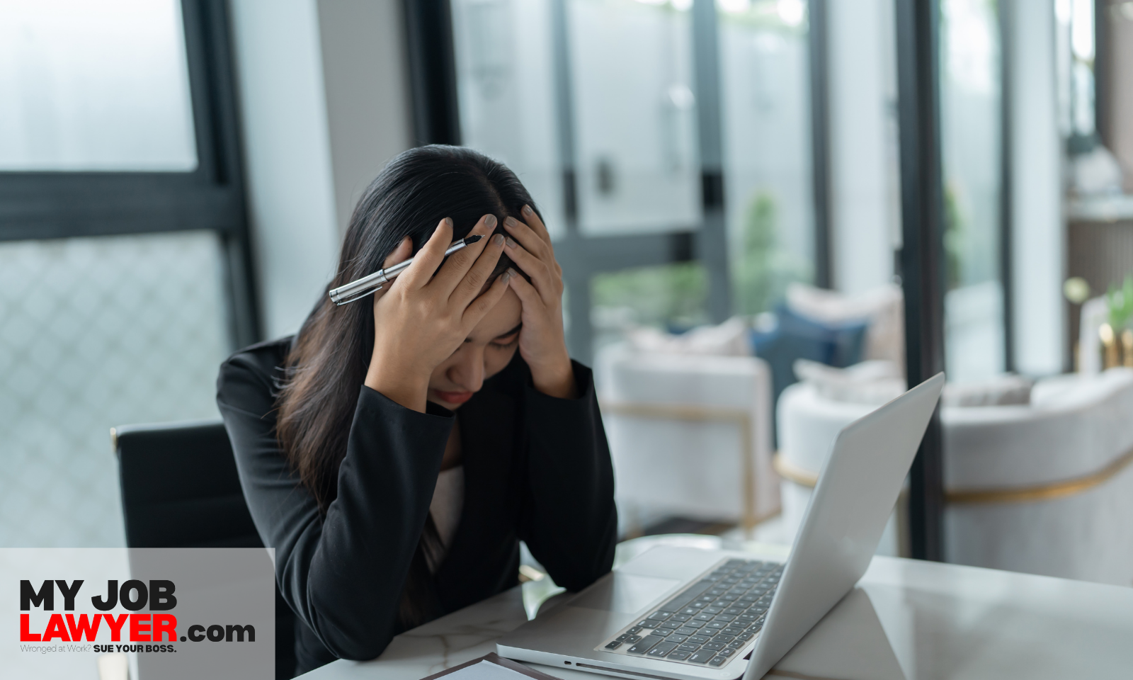 Stressed employee dealing with issues that can influence the average settlement for retaliation lawsuit amount.