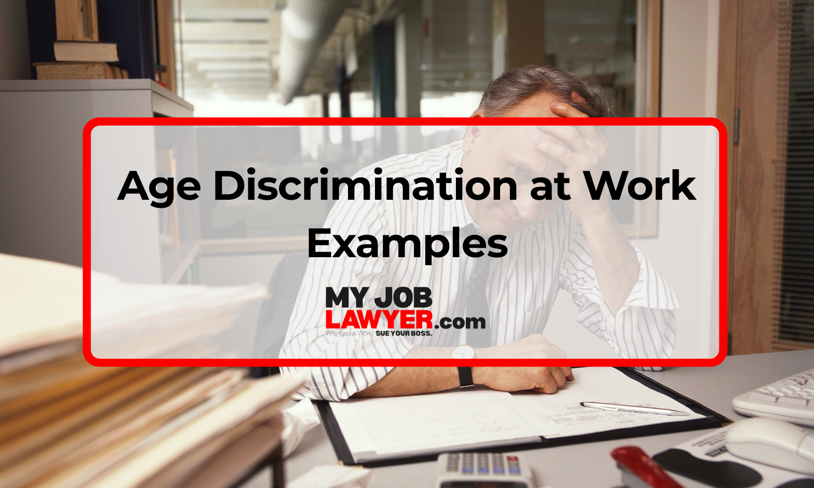 Older office worker looking worried at desk while younger coworkers talk in the background, representing age discrimination at work examples.