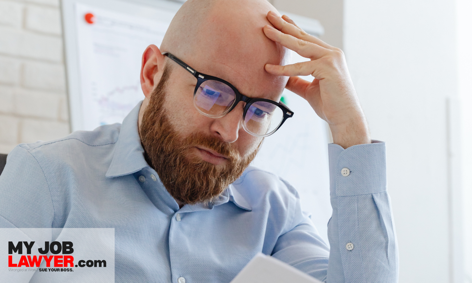 Employee reviewing incorrect payment or termination paperwork, representing employer breach of employment contract.