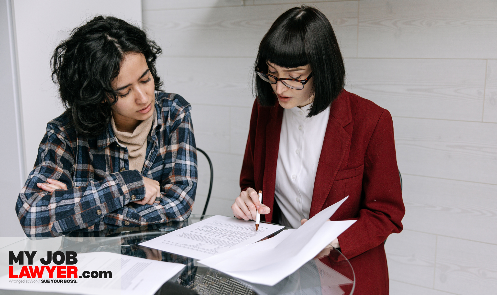 Employee consulting with an employment lawyer about legal rights after a breach of employment contract.